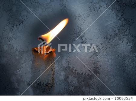 Closeup photo of little candle flame behind frozen window glass 10093534