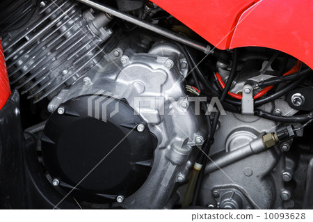Sport motorcycle engine under red cover, closeup photo 10093628