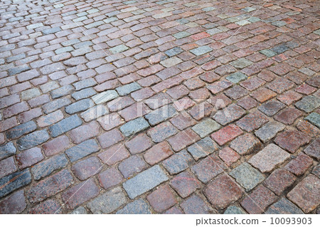 Background texture of old wet granite cobblestone road 10093903