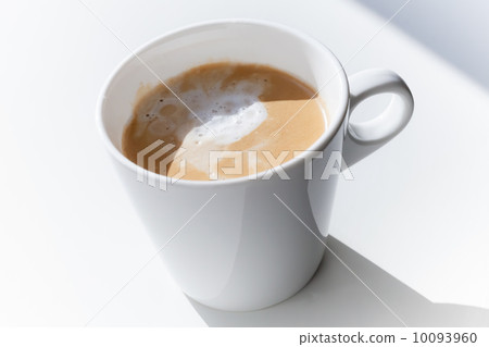 Cappuccino coffee in a ceramic cup on white table Cappuccino coffee in a ceramic cup on white table 10093960
