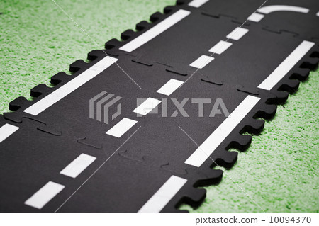 Abstract road background with playground carpet and toy road tiles Abstract road background with playground carpet and toy road tiles 10094370