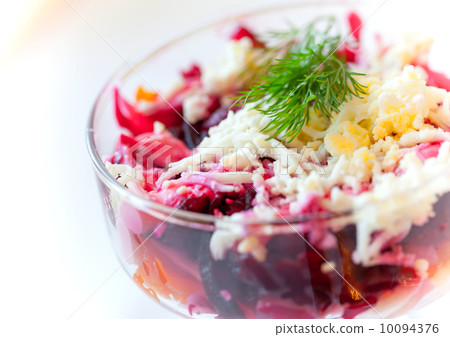 Traditional Russian salad with herring and beet. Closeup photo with selective focus 10094376