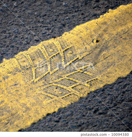 Abstract road background with yellow line and tire imprint on th Abstract road background with yellow line and tire imprint on th 10094380