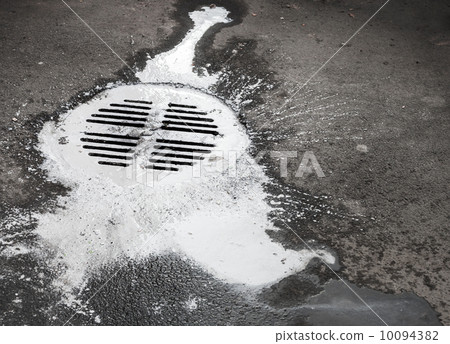 White paint flows into the manhole. Pollution metaphor White paint flows into the manhole. Pollution metaphor 10094382