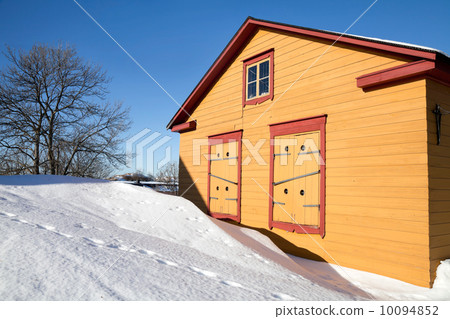 Rural yellow wooden house in winter season with snowdrifts. Rural yellow wooden house in winter season with snowdrifts. 10094852