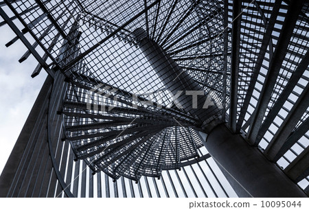 Metal modern spiral staircase details above blue sky 10095044