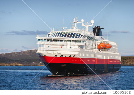 Big Norwegian passenger cruise ship sails in fjord 10095108