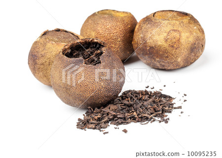 Chinese black tea Pu-erh packed in dried mandarins isolated 10095235