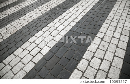 Pedestrian crossing with road marking: white rectangles on gray granite cobblestone road Pedestrian crossing with road marking: white rectangles on gray granite cobblestone road 10095237