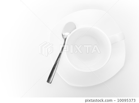 White ceramic cup on saucer with metal spoon above white background. Top view White ceramic cup on saucer with metal spoon above white background. Top view 10095373