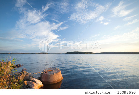 Concrete mooring bollard with ships chain on the coast of Saimaa lake in Finland 10095686