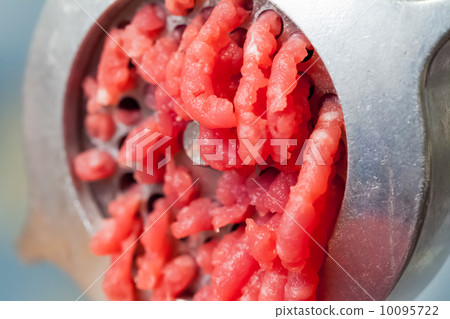 Macro photo of mincer machine with fresh chopped meat Macro photo of mincer machine with fresh chopped meat 10095722