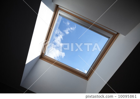 Looking up to the blue cloudy sky through modern square ceiling window 10095861