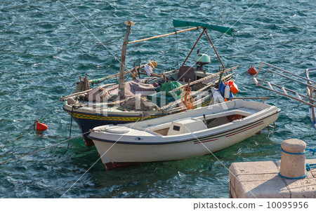 Two wooden fishing boats stay moored in Petrovac town, Montenegr 10095956