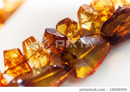Macro photo of amber beads on white background Macro photo of amber beads on white background 10096094