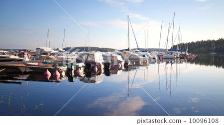 Yachts and motorboats moored in small European marina. Imatra town, Saimaa lake, Finland Yachts and motorboats moored in small European marina. Imatra town, Saimaa lake, Finland 10096108