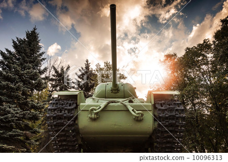 Soviet heavy KV-85 tank from the Second World War with forest and dramatic sky on a background. Monument in St-Petersburg 10096313