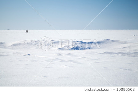 Deep blue sky and snow on frozen Baltic Sea with people walking on ice 10096508