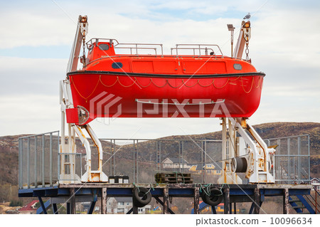 Red rescue boat stands on the coast in Norway 10096634
