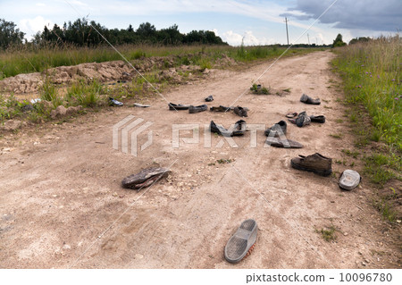 Old rural road with abandoned shoes 10096780