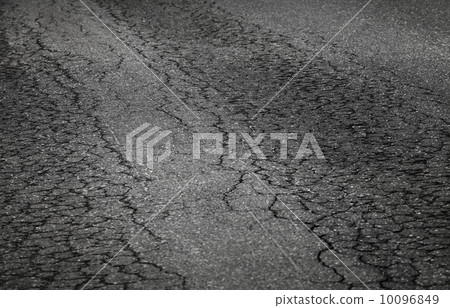 Closeup photo of damaged asphalt road 10096849