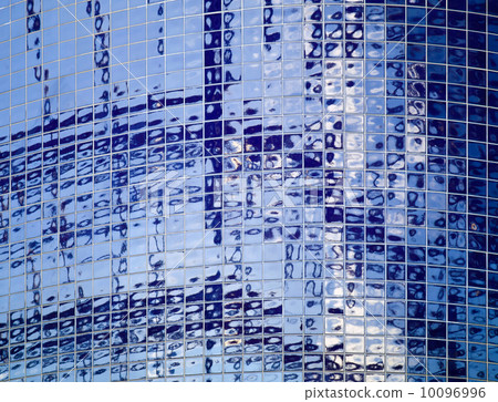 Blue tiling on a round wall with bright abstract reflection Blue tiling on a round wall with bright abstract reflection 10096996