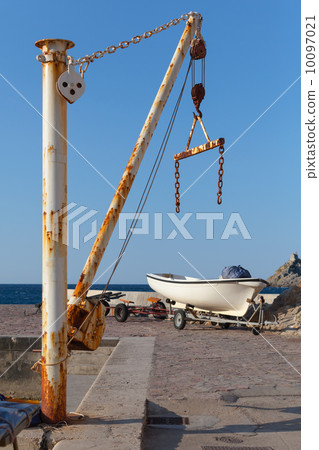 White fishing boat and small crane in port of Petrovac town, Mon White fishing boat and small crane in port of Petrovac town, Mon 10097021