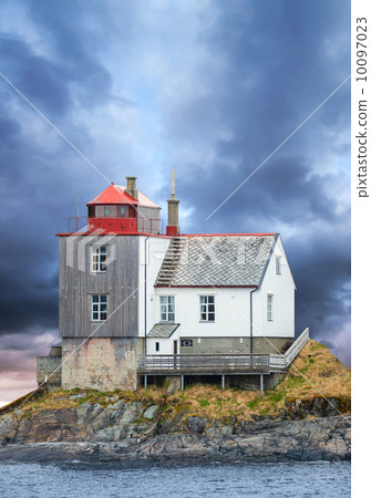 Old Norwegian lighthouse on rocky island with dramatic sky 10097023