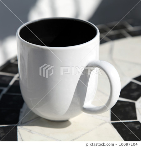 White coffee cup stands on round table 10097104