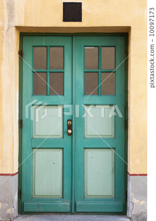Green wooden door with windows in old building facade. Tallinn, Estonia Green wooden door with windows in old building facade. Tallinn, Estonia 10097173