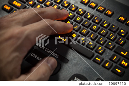 Hand on illuminated industrial qwerty keyboard. Selective focus Hand on illuminated industrial qwerty keyboard. Selective focus 10097330