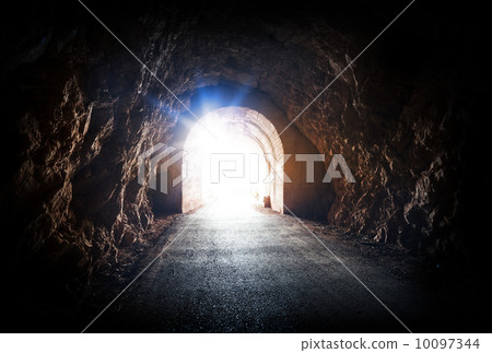 End of dark tunnel with magic blue light from the outside 10097344