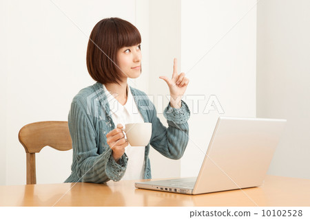 A woman watching a personal computer 10102528