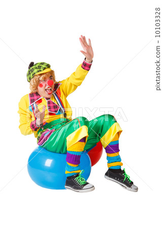 Funny clown sits on blue ball isolated on white background Funny clown sits on blue ball isolated on white background 10103328