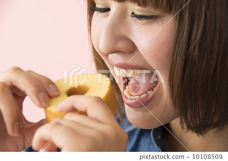 A woman eating a snack 10108509