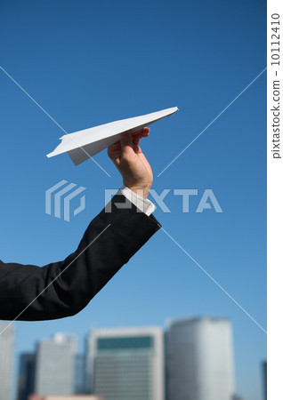 Women's hand with paper airplane 10112410