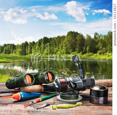 fishing tackle on a pontoon on the background of the lake fishing tackle on a pontoon on the background of the lake 10113627
