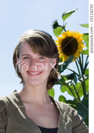 Young woman and a sunflower Young woman and a sunflower 10118250