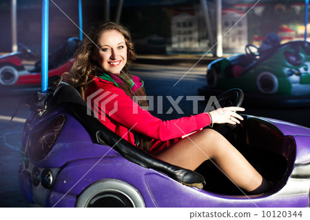 Teenage girl in an electric bumper car  10120344