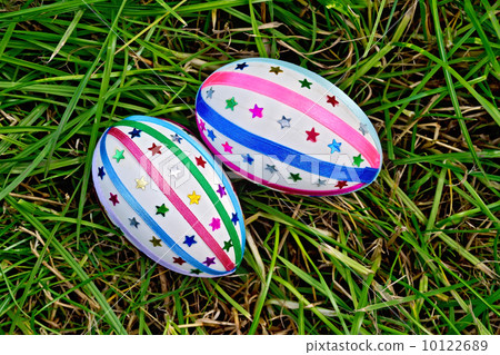 Easter eggs with ribbons and sequins on grass Easter eggs with ribbons and sequins on grass 10122689