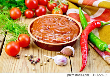Ketchup in pottery with vegetables on board Ketchup in pottery with vegetables on board 10122696