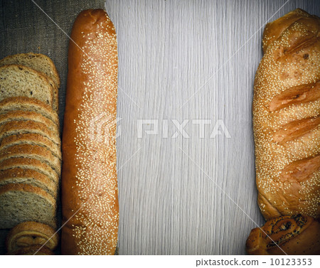 Fresh Tasty Bread on Woody Background 10123353