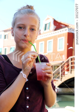 Cute girl with red slush drink 10127077