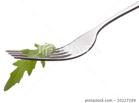 Fresh rucola salad on fork isolated on white background cutout. Fresh rucola salad on fork isolated on white background cutout. 10127289