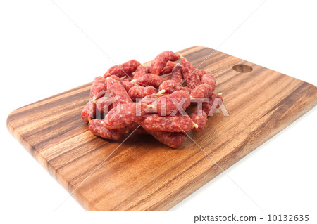 A heap of mini Salamis on wooden board 10132635