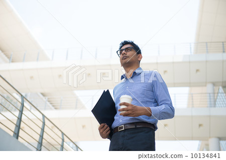 indian business male with coffee and folder indian business male with coffee and folder 10134841