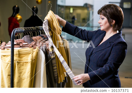 two happy women shopping in clothes store 10137371
