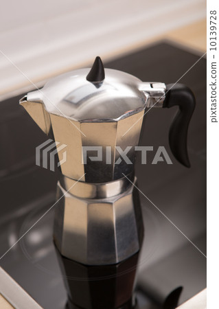 Italian coffee pot on a electric cooker. 10139728
