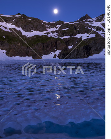 Moonlight view of a frozen lake in high alpine area 10140840
