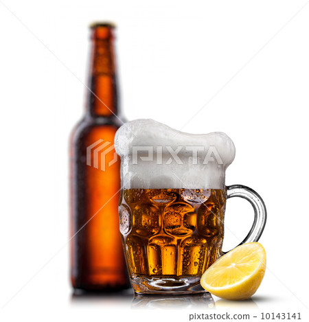 Beer in glass with water drops and lemon against bottle isolated Beer in glass with water drops and lemon against bottle isolated 10143141